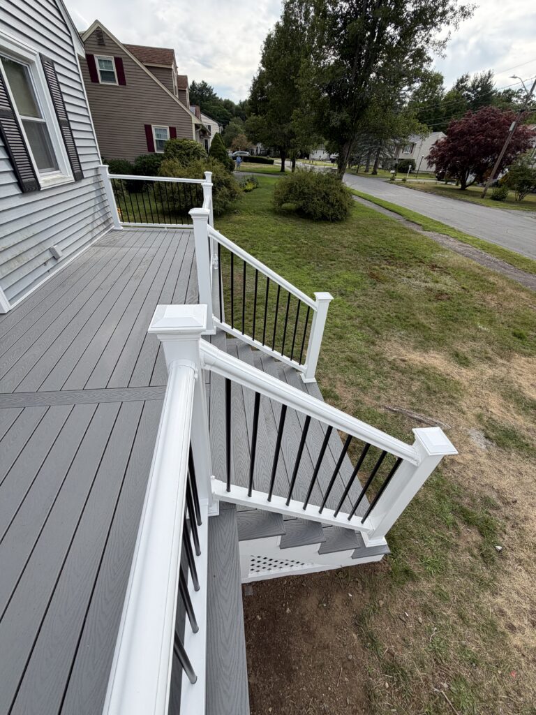 Deck staircase with white railings built by J&J All Seasons Corp